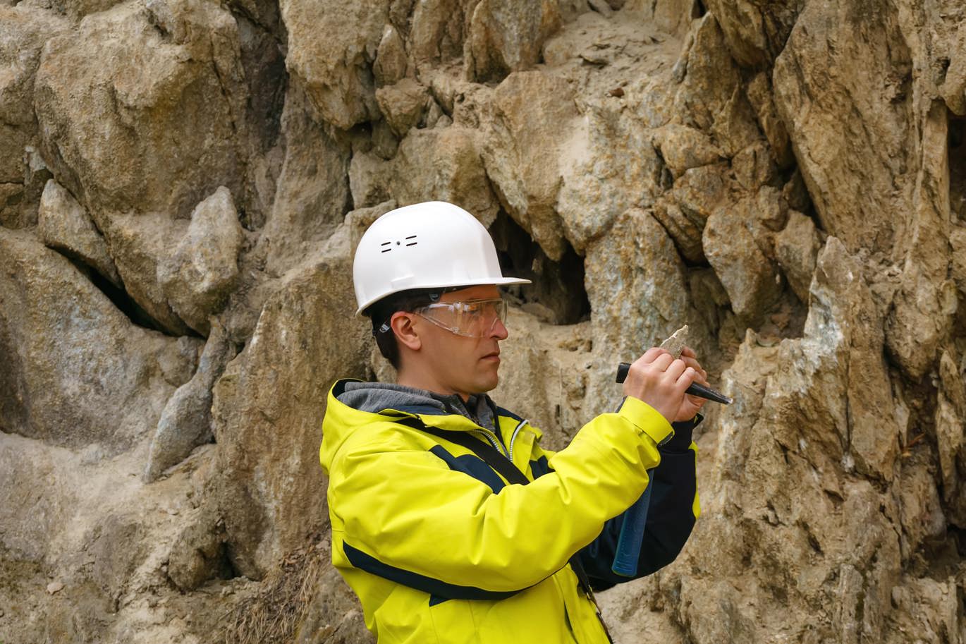 Man looking at a rock sample